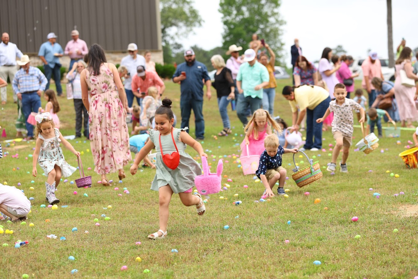 Children running through Easter egg field
