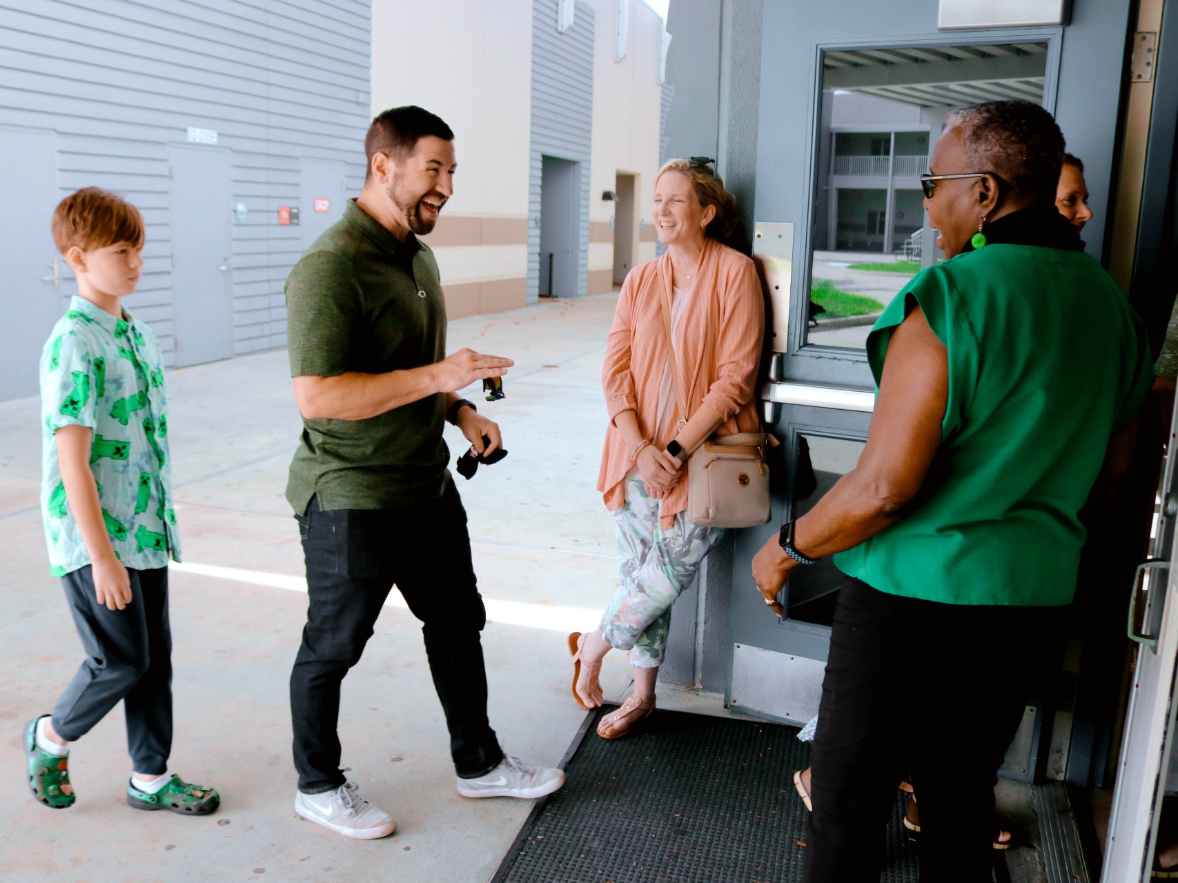 Greeters welcoming guests at the entrance of Redeem Church