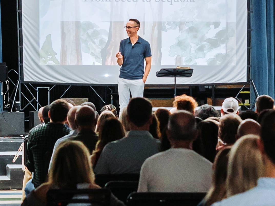 Pastor teaching from an open Bible