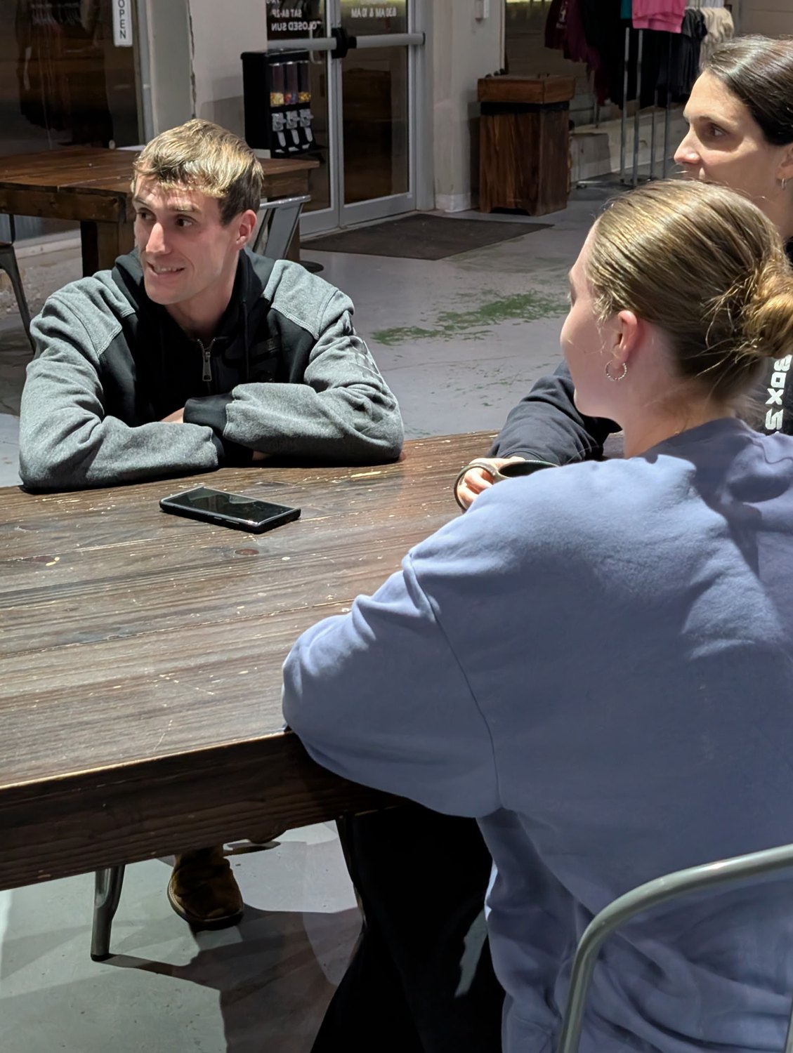 Two young adults talking across a table