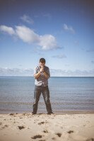 Man Praying on Beach