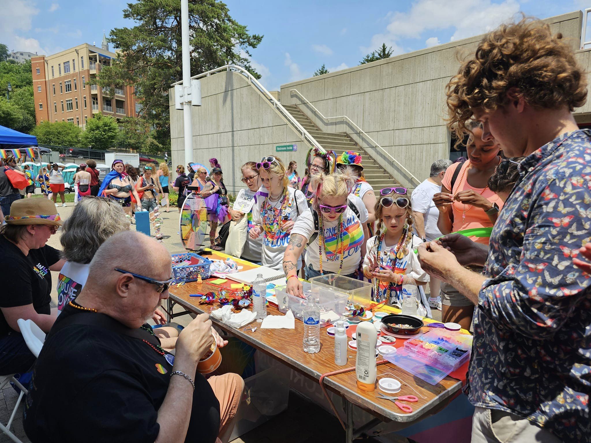 People picking out gifts at LCR's Pride Booth