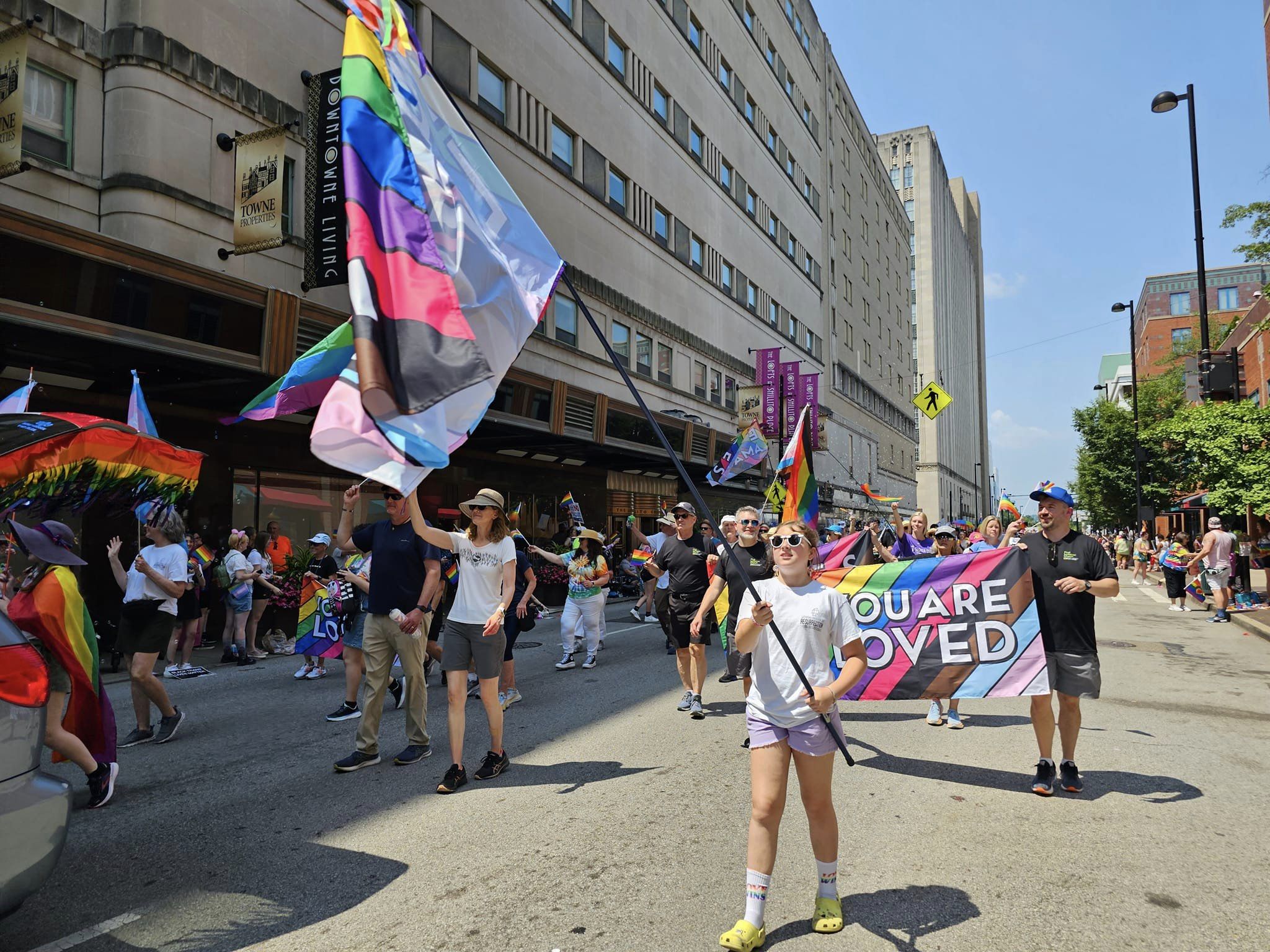 LCR members marching in the Pride Parade 2023, one young girl is waving a Pride flag