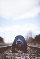 Man Praying on Train Tracks