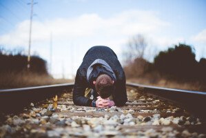 Man Praying on Train Tracks