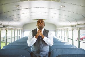 Man Praying on Bus