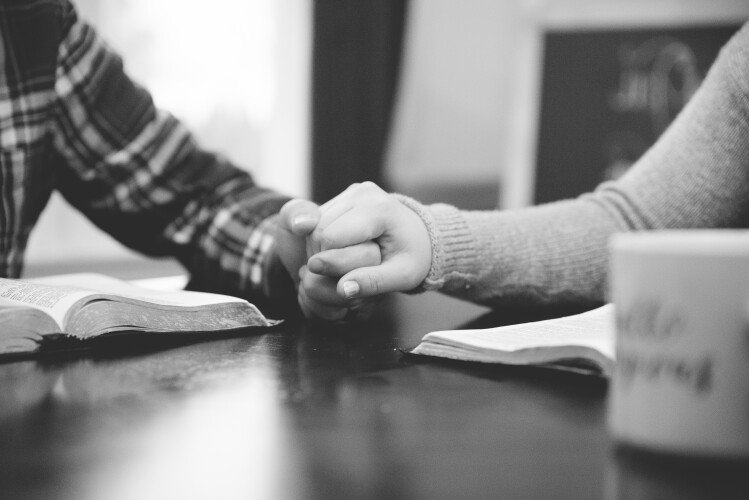 Couple Reading Bible & Holding Hands (2)